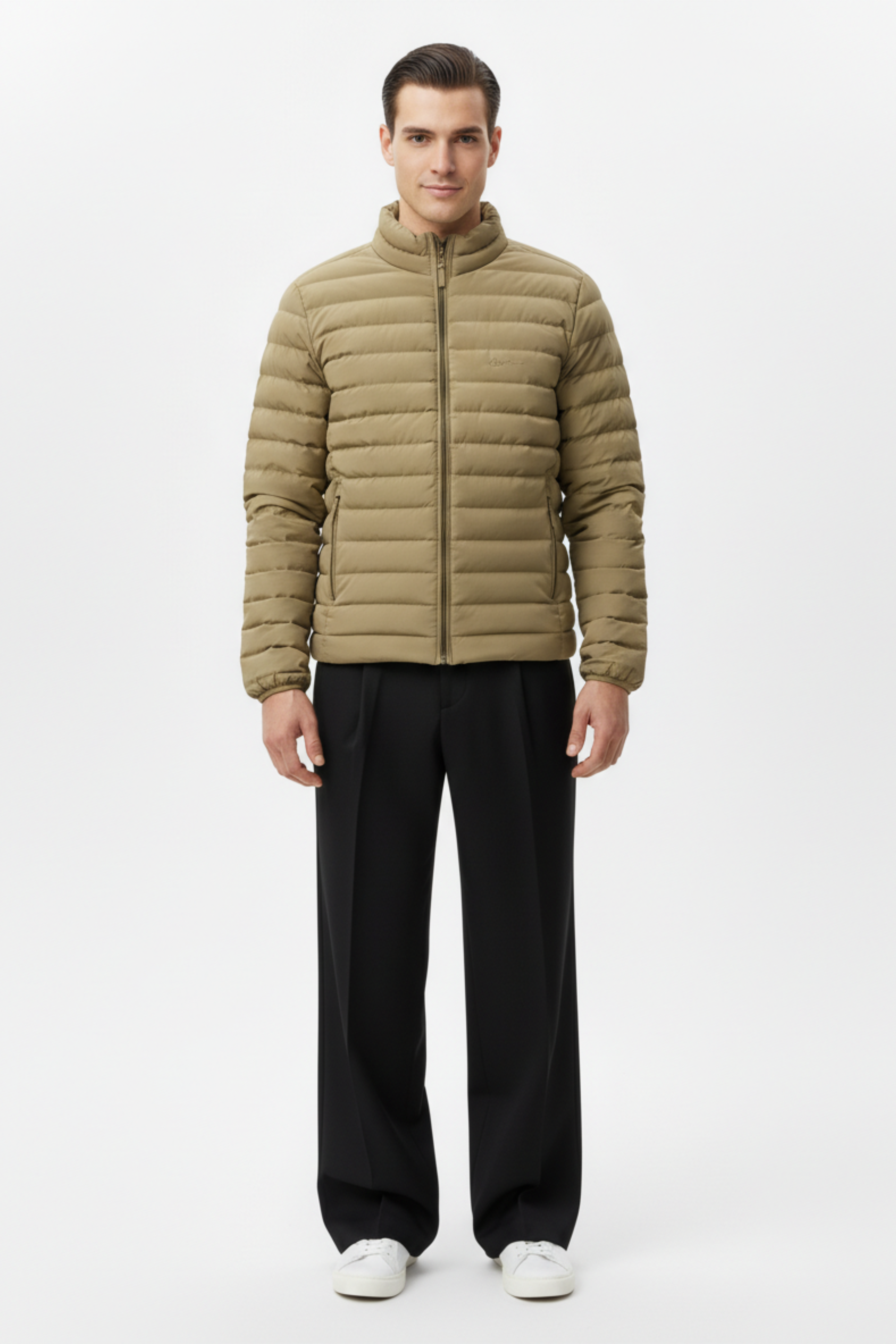 Full-length view of a man wearing a beige mens puffer jacket with black trousers