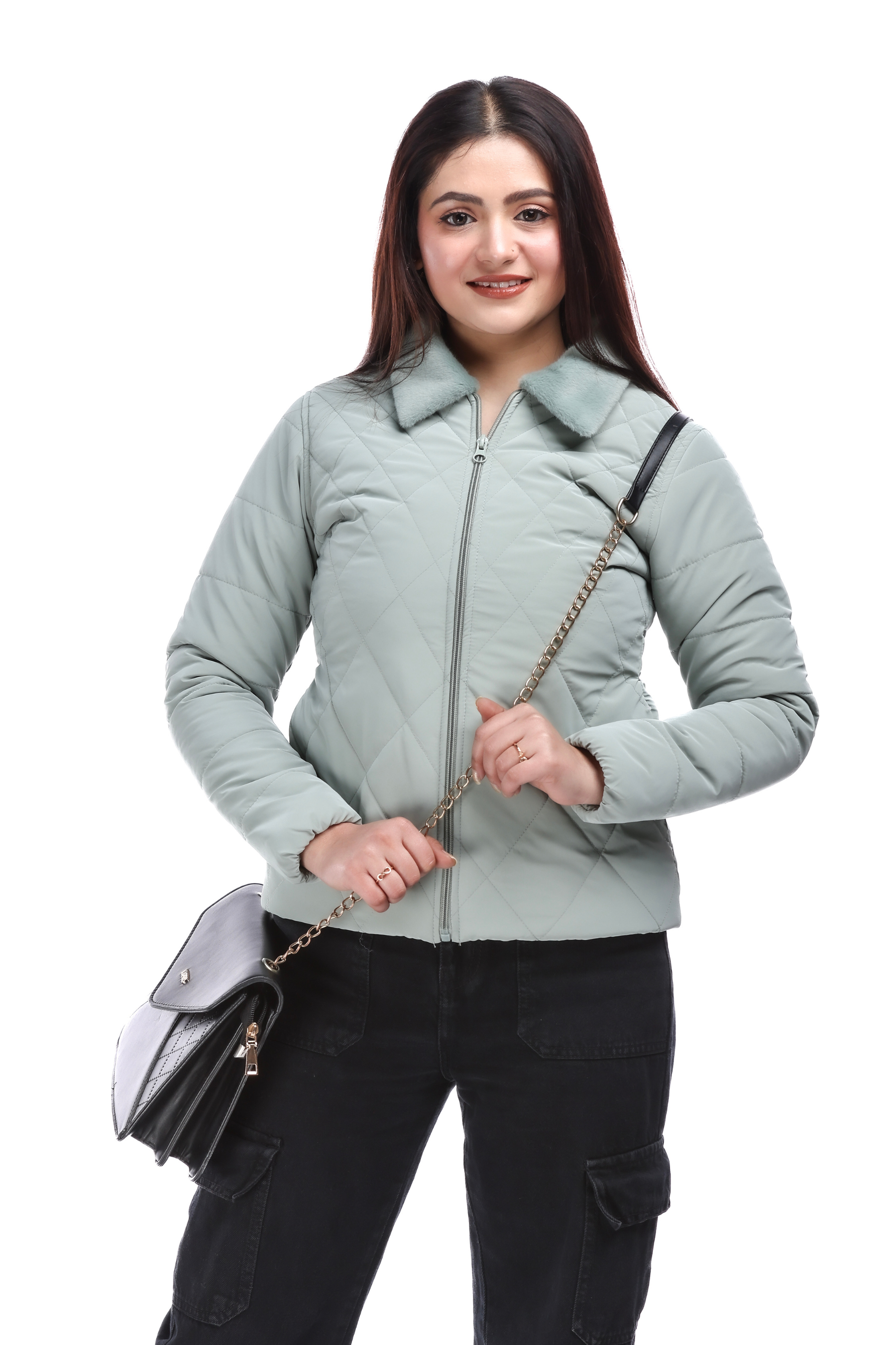 Woman wearing a blue faux-fur pu jacket, styled with black cargo pants, black boots, and a shoulder bag, standing confidently with a smile.