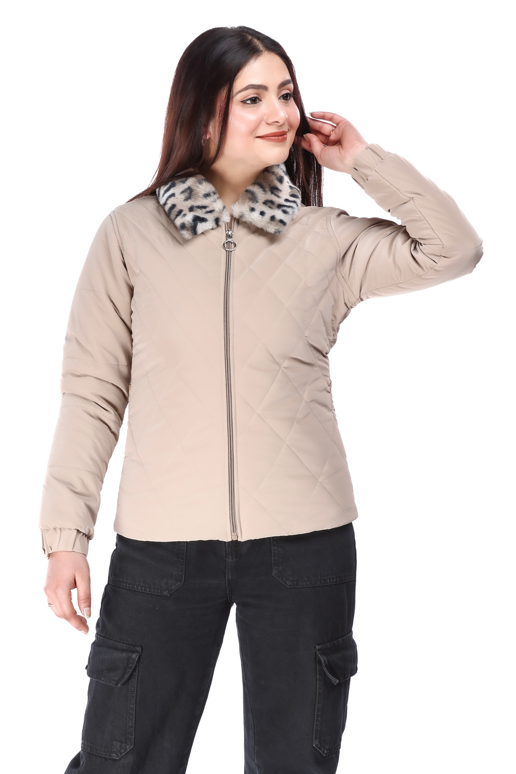 Woman wearing a cream faux-fur PU jacket with a zip-up front and animal print faux-fur collar, paired with black cargo pants and black boots, posing with one hand touching her hair and smiling to the side.