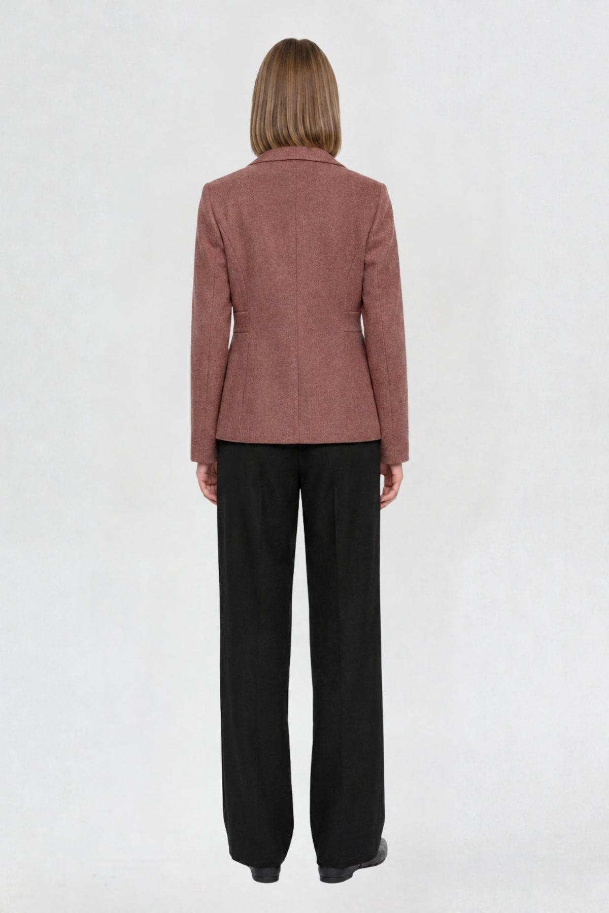 Back view of dark onion short blazer coat showing tailored back seams and welt pocket detail