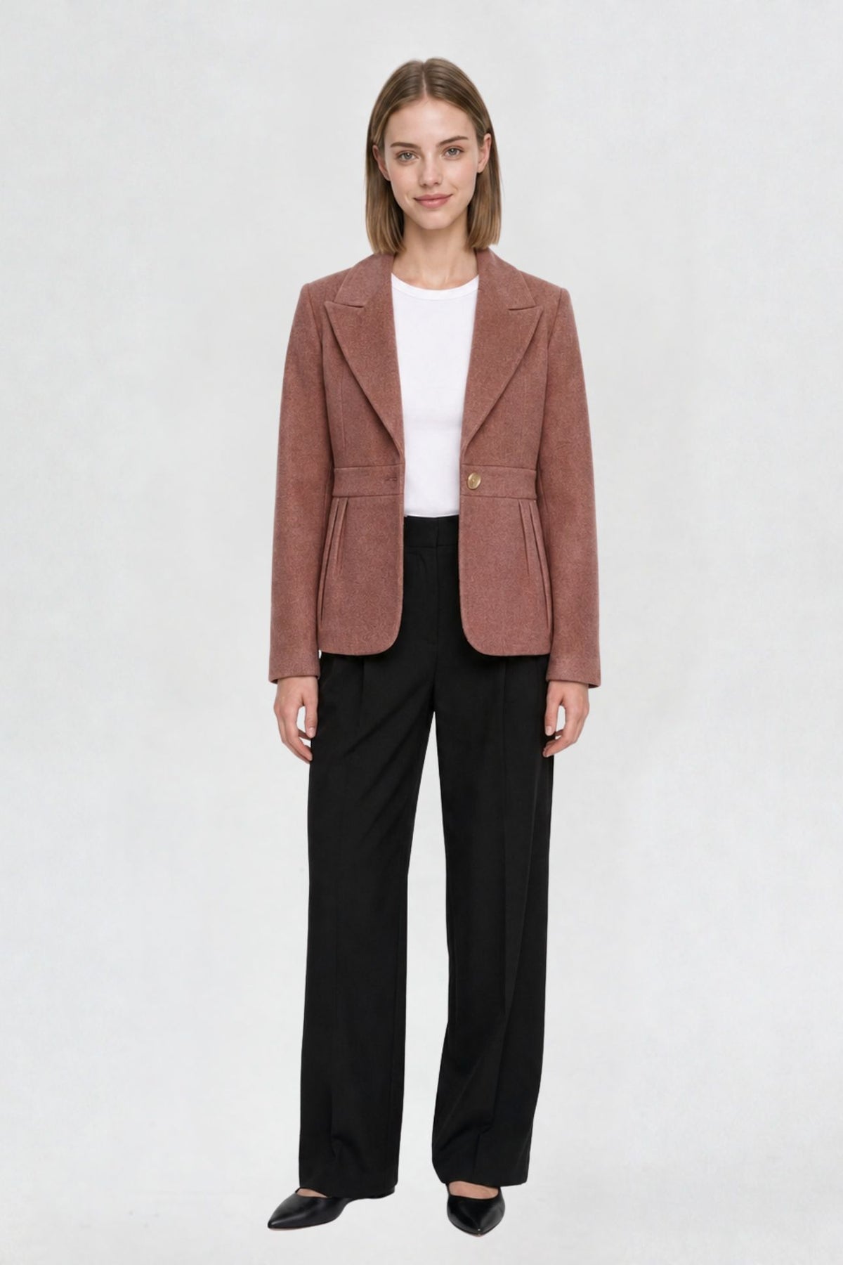 Women's dark onion short blazer coat, full front view, single-button closure, pleated peplum hem, styled with black wide-leg trousers