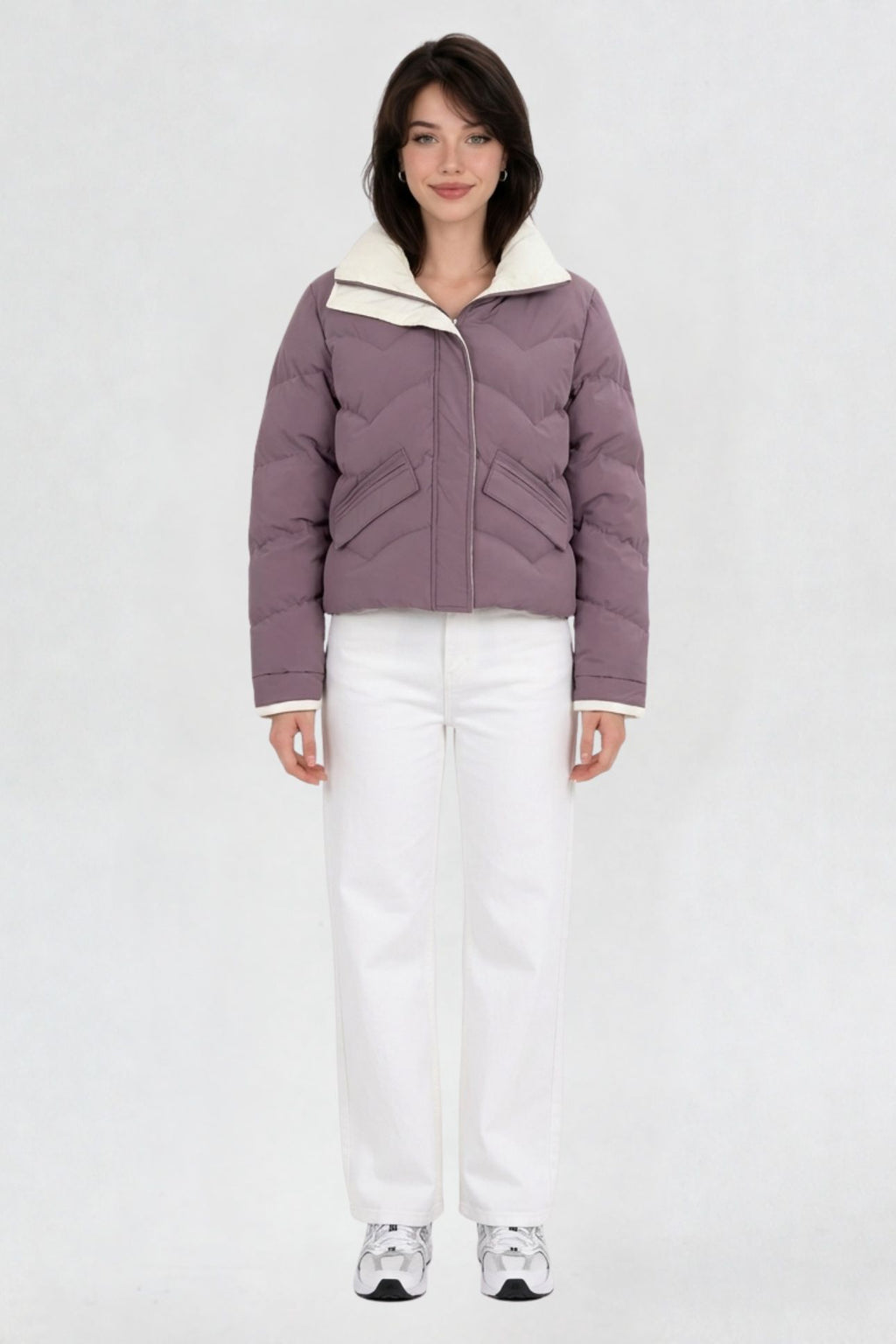 Women's mauve purple puffer jacket, full front view, quilted chevron pattern with cream lining, worn with white jeans and sneakers