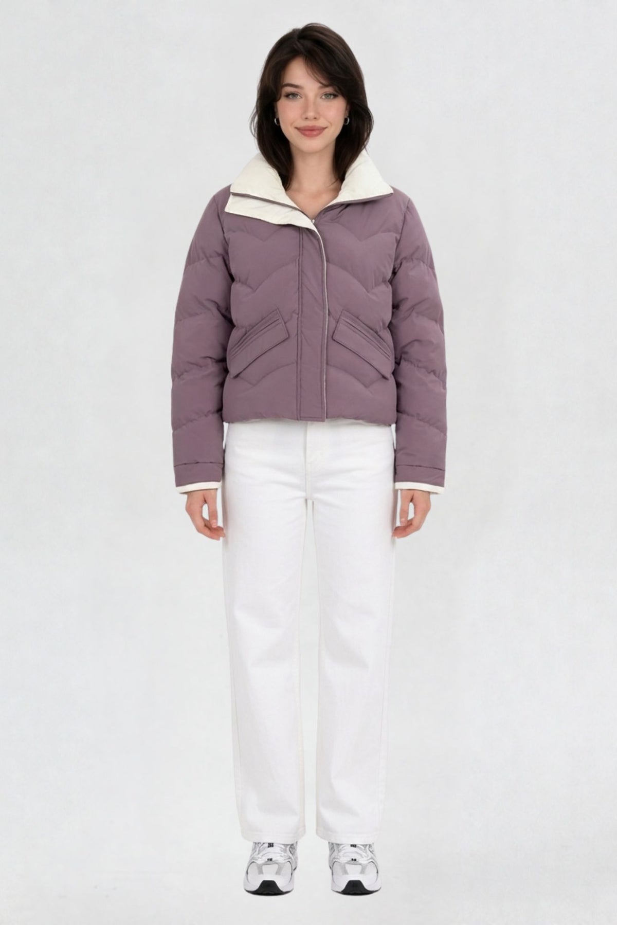Women's mauve purple puffer jacket, full front view, quilted chevron pattern with cream lining, worn with white jeans and sneakers