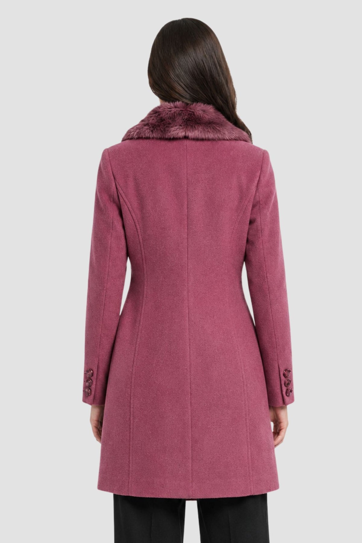 Back view of pink faux fur overcoat showing tailored back seams and button cuff detail