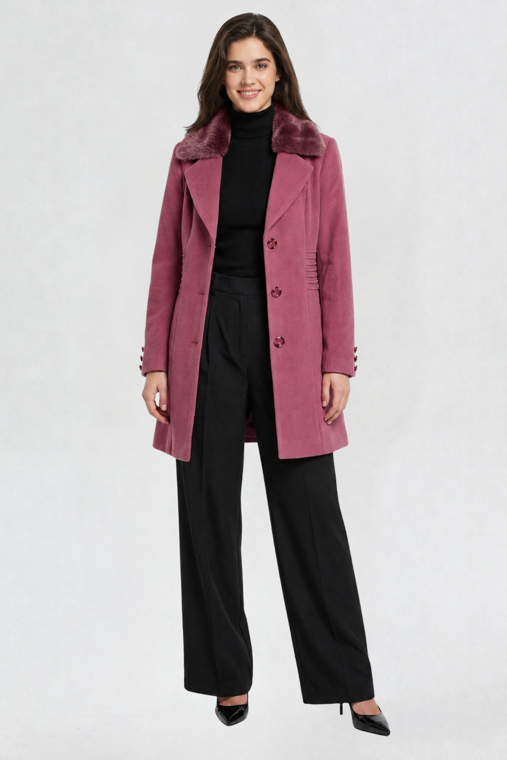 women's pink faux fur overcoat, front view, faux fur collar and button closure, styled with black turtleneck and trousers