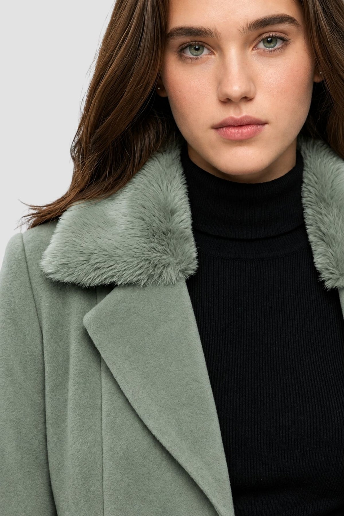 Close-up of pista green faux fur overcoat showing faux fur collar and notch lapel detail