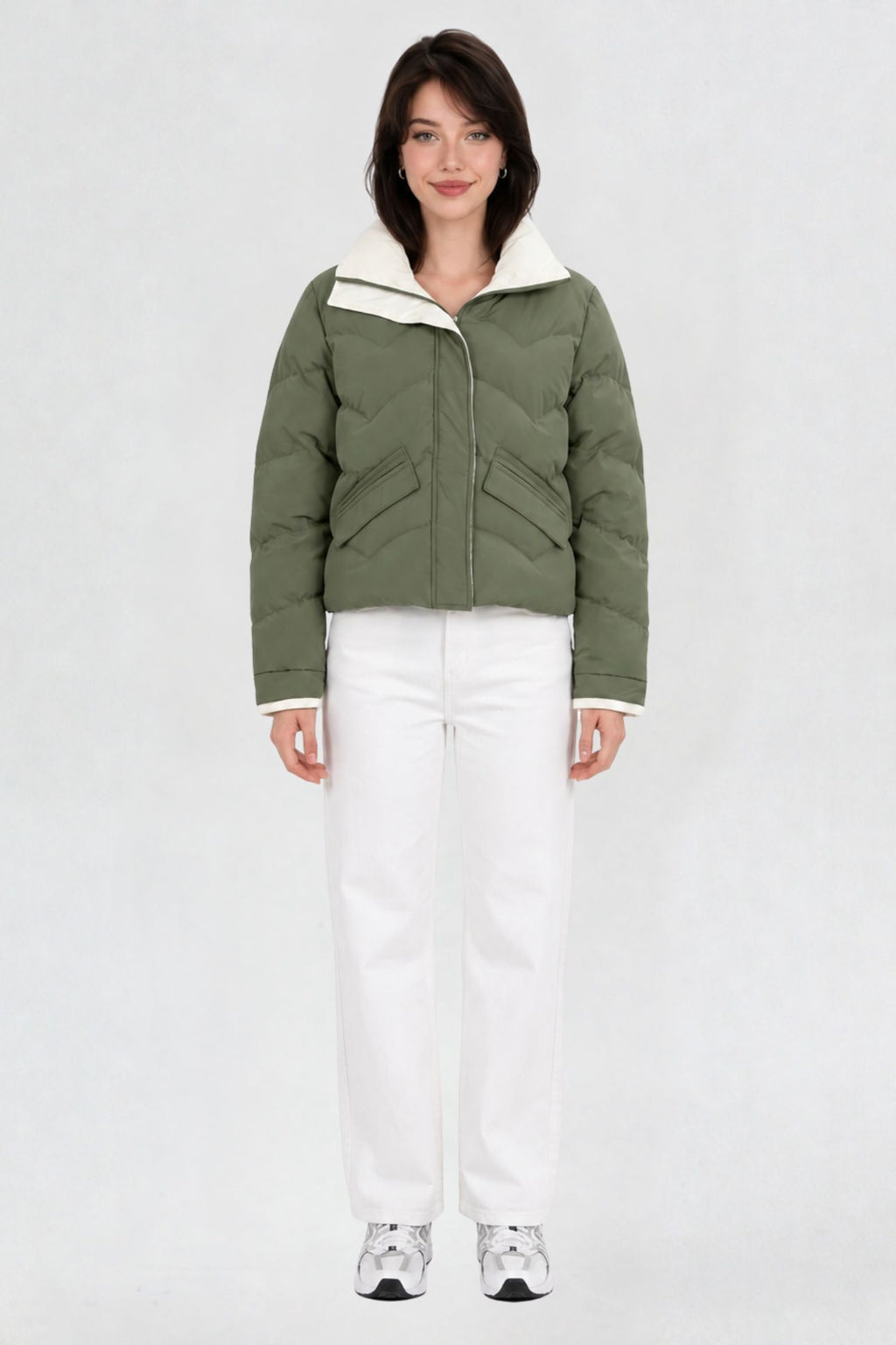 Women's pista green puffer jacket, full front view, quilted chevron pattern with cream lining, worn with white jeans and sneakers