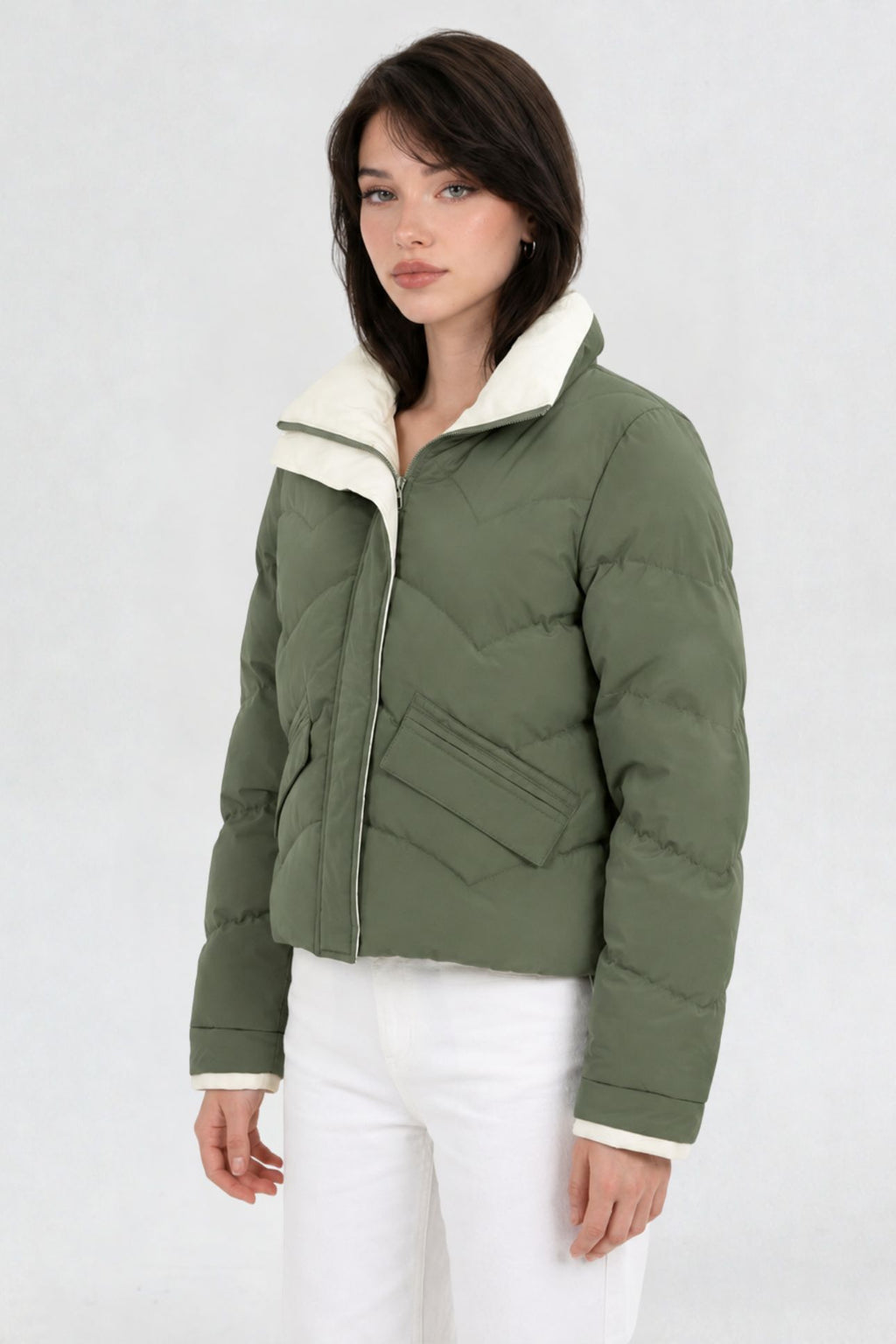 Side view of pista green puffer jacket showing cream contrast collar and flap pocket detail
