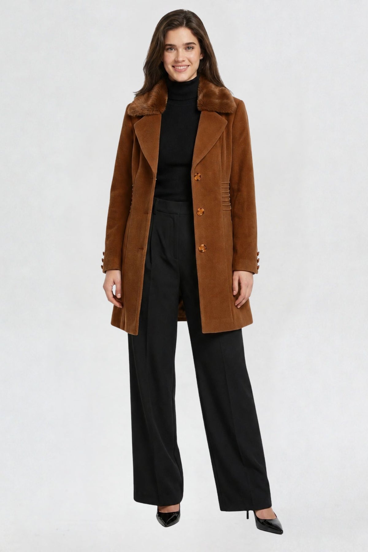 women's tan brown faux fur overcoat, front view, faux fur collar and button closure, styled with black turtleneck and trousers